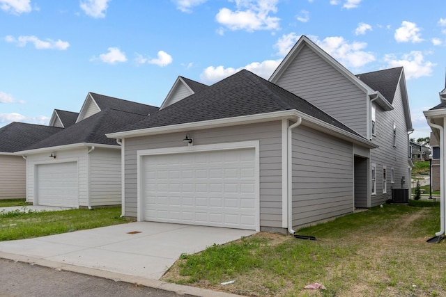 view of home's exterior with a garage, a yard, and central AC unit