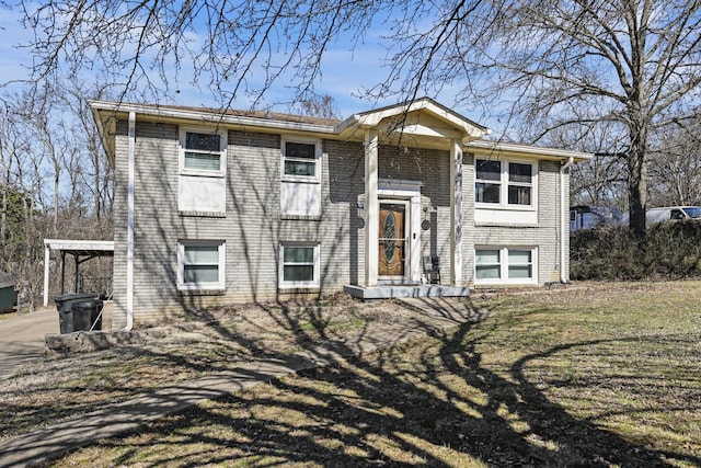 raised ranch featuring brick siding