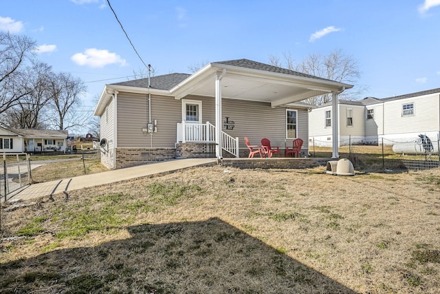 rear view of house featuring a yard