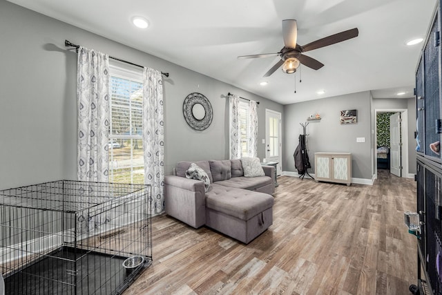 living room featuring hardwood / wood-style flooring and ceiling fan