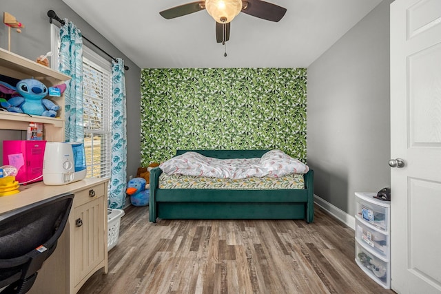 bedroom with hardwood / wood-style flooring and ceiling fan