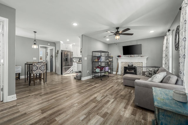 living room with wood-type flooring and ceiling fan