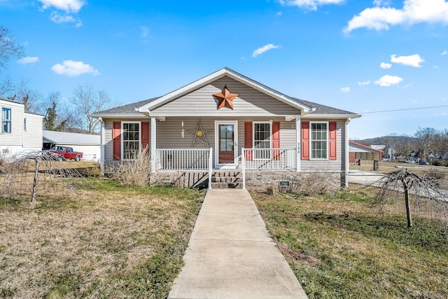 view of front of property featuring a front lawn, a carport, and a porch