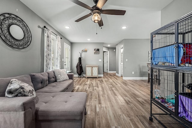 living room featuring hardwood / wood-style flooring and ceiling fan