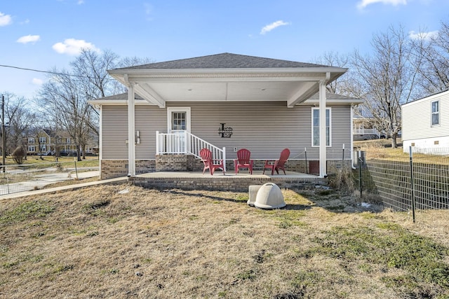 back of property featuring a patio area and a lawn