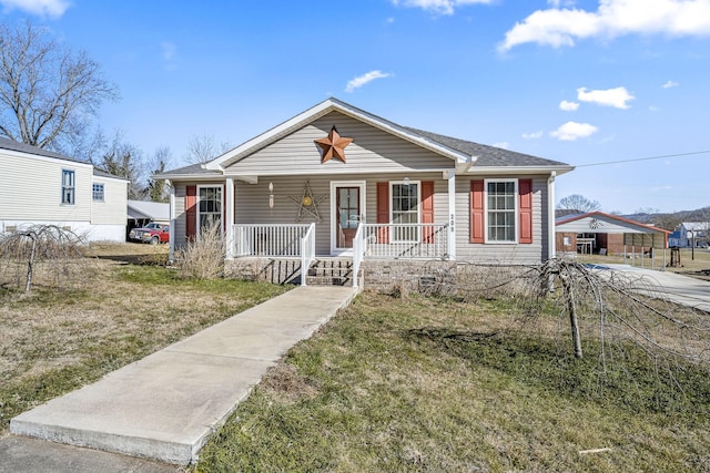 bungalow-style house with a front lawn and covered porch