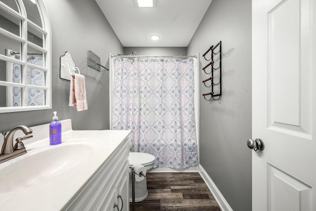 bathroom featuring vanity, toilet, hardwood / wood-style floors, and a shower with curtain