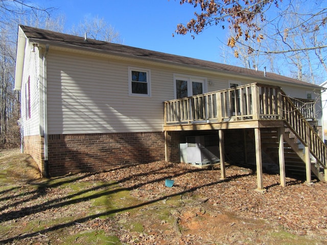 rear view of property featuring a wooden deck