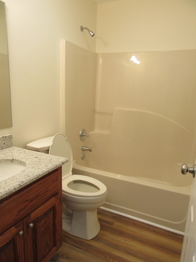 full bathroom with vanity, hardwood / wood-style flooring, toilet, and shower / bath combination