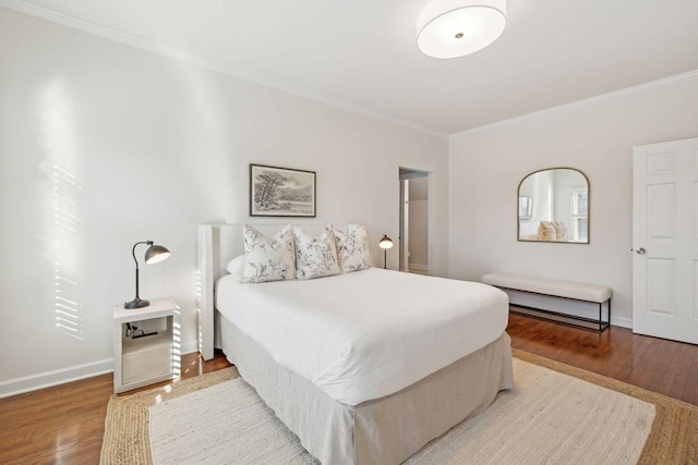 bedroom featuring wood-type flooring and crown molding