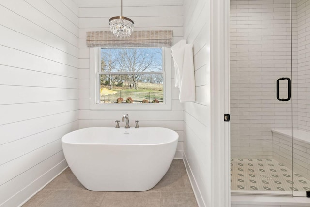 bathroom featuring tile patterned floors, wooden walls, a chandelier, and plus walk in shower