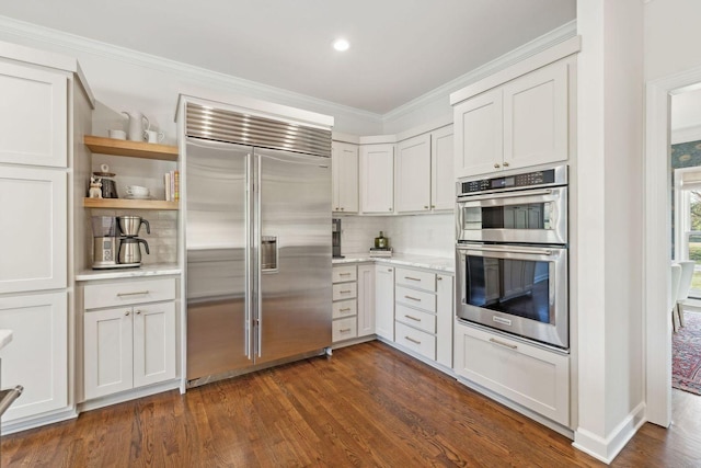 kitchen with white cabinetry, dark hardwood / wood-style flooring, and appliances with stainless steel finishes