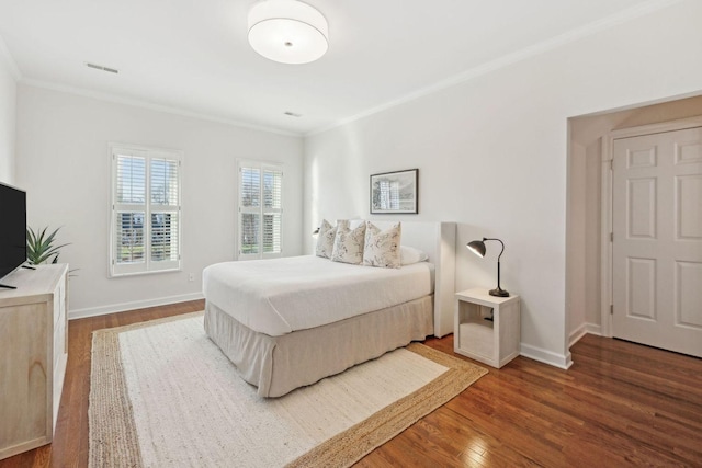 bedroom featuring crown molding and wood-type flooring