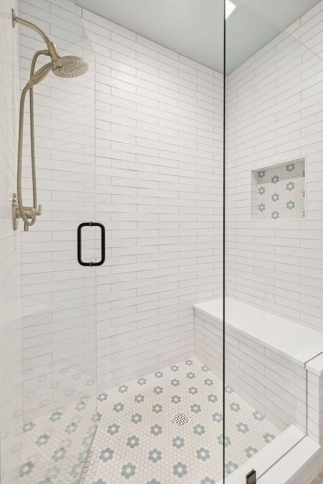 bathroom featuring a shower with shower door