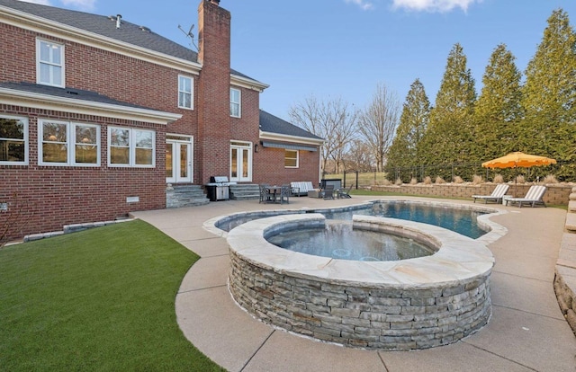 view of pool with area for grilling, a patio, and an in ground hot tub