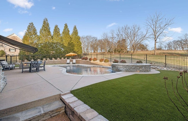 view of pool with a patio, pool water feature, and a yard