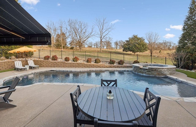 view of swimming pool featuring an in ground hot tub, a rural view, and a patio