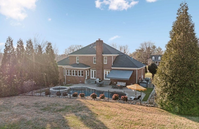 back of property featuring a yard and a patio