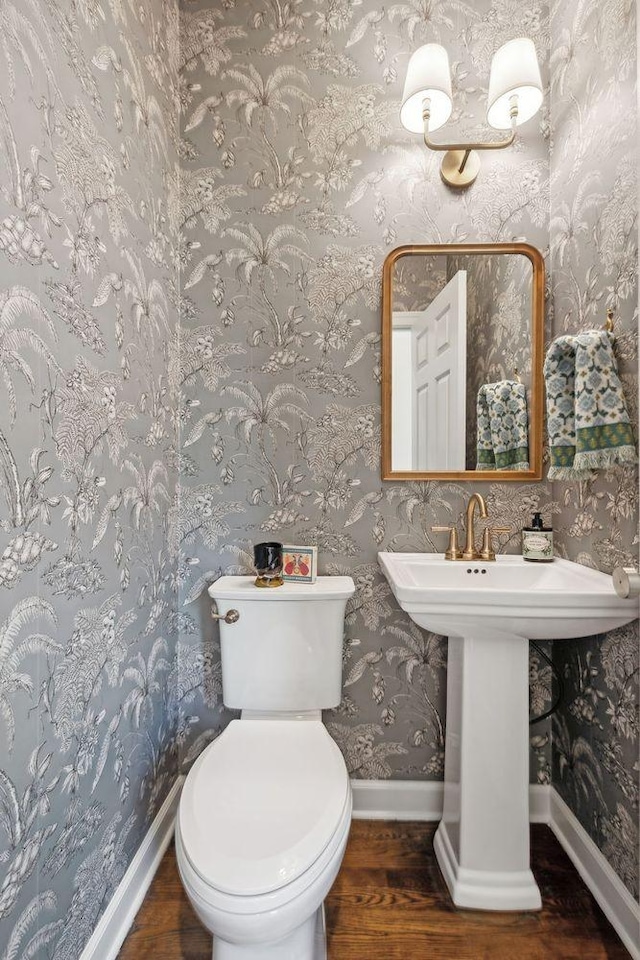 bathroom featuring wood-type flooring and toilet