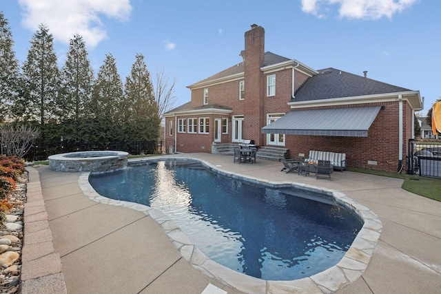 view of pool with an in ground hot tub, grilling area, and a patio