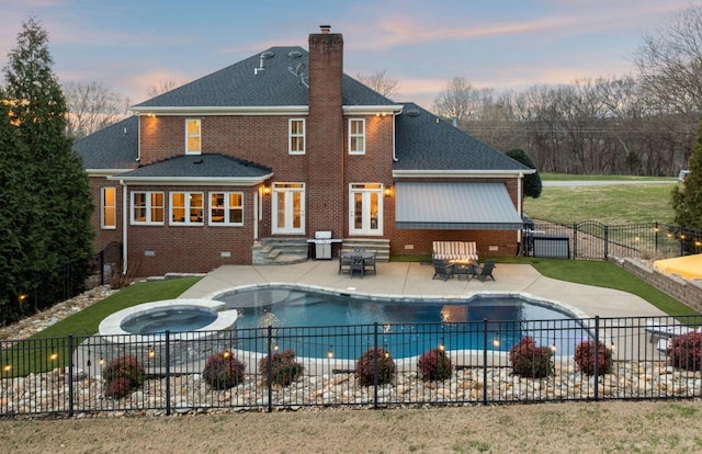 pool at dusk featuring a grill, an outdoor fire pit, a patio, and an in ground hot tub