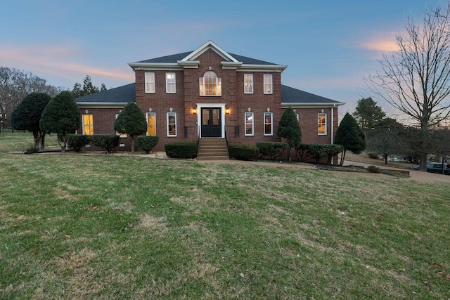 colonial home featuring a yard