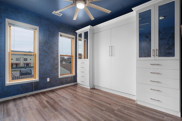 unfurnished bedroom featuring dark wood-type flooring and ceiling fan