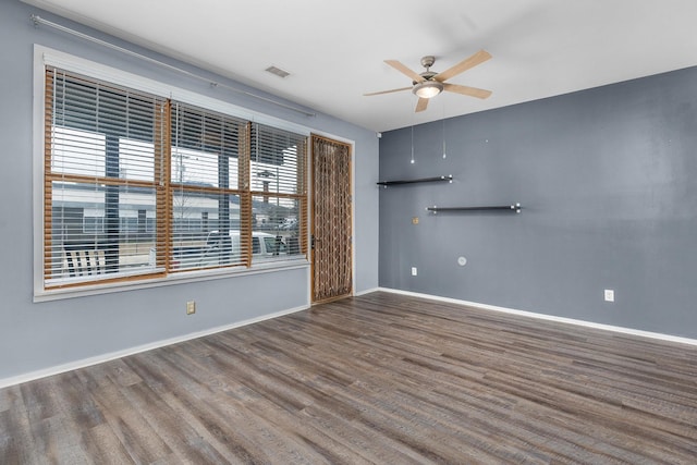 spare room featuring dark hardwood / wood-style floors and ceiling fan