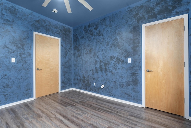 spare room featuring ceiling fan and dark hardwood / wood-style flooring