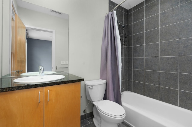 full bathroom with tile patterned floors, vanity, toilet, and shower / bath combo