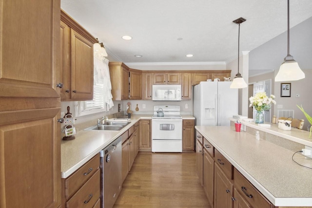 kitchen featuring sink, light wood-type flooring, hanging light fixtures, crown molding, and white appliances