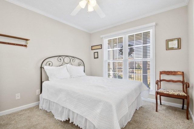 bedroom featuring ornamental molding, light colored carpet, and ceiling fan