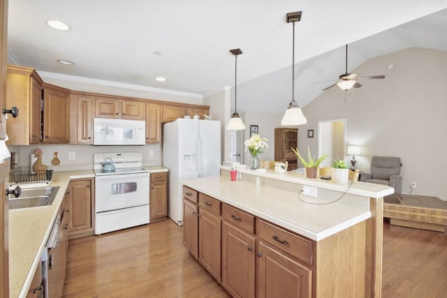 kitchen with vaulted ceiling, a kitchen island, sink, hanging light fixtures, and white appliances