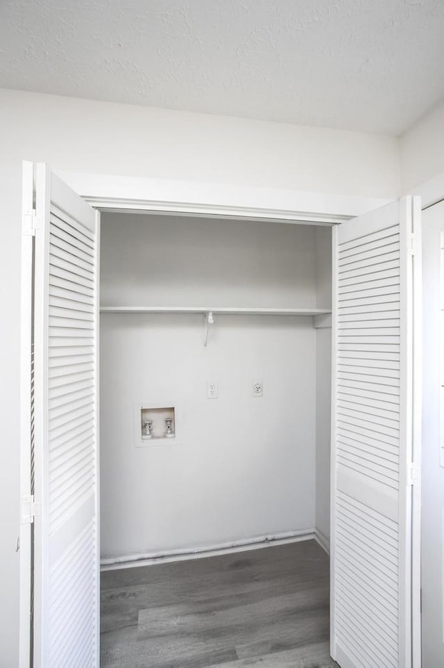 washroom with hookup for a washing machine, dark hardwood / wood-style floors, and hookup for an electric dryer