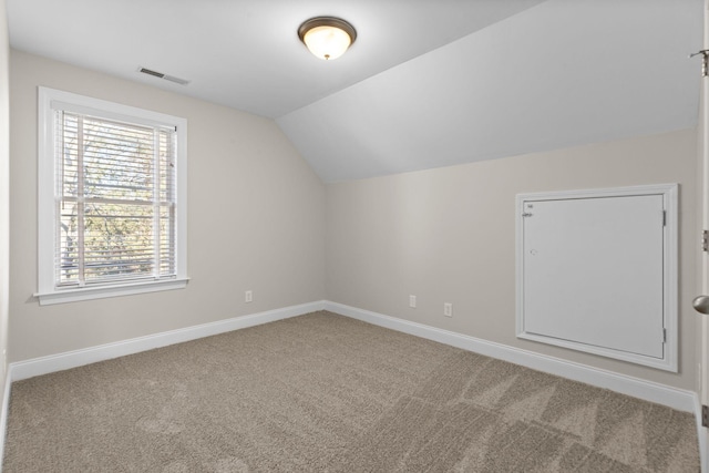 bonus room featuring lofted ceiling and carpet flooring