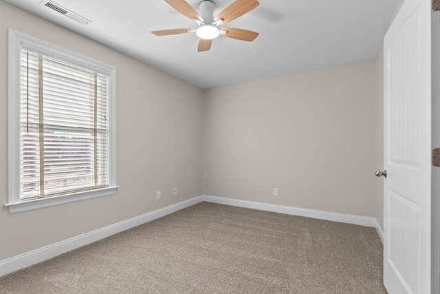 carpeted spare room featuring ceiling fan