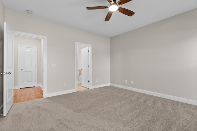 unfurnished bedroom with ceiling fan, connected bathroom, and light carpet