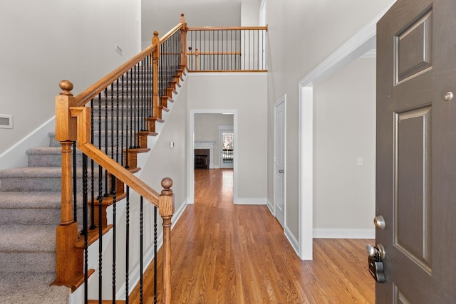 entryway featuring light hardwood / wood-style floors and a high ceiling