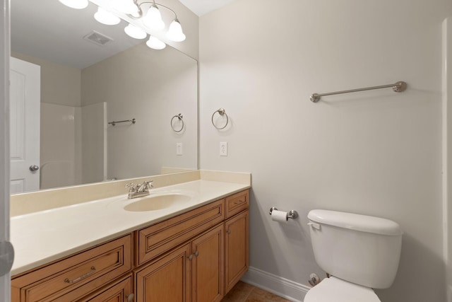 bathroom featuring walk in shower, tile patterned floors, toilet, vanity, and a notable chandelier