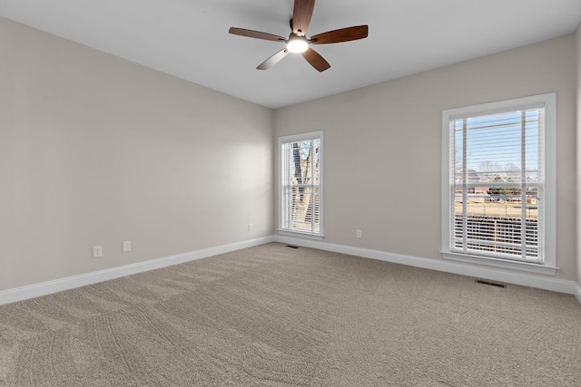 carpeted spare room with ceiling fan