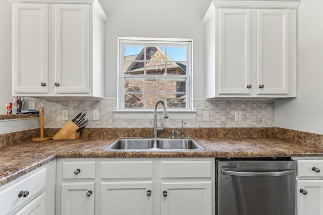 kitchen featuring dishwasher, sink, white cabinets, and backsplash