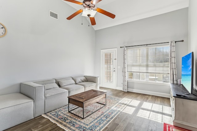 living room featuring wood-type flooring, high vaulted ceiling, and ceiling fan