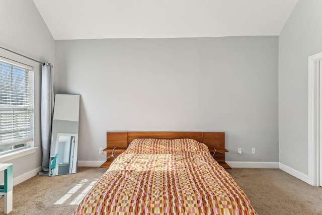 bedroom featuring lofted ceiling and carpet