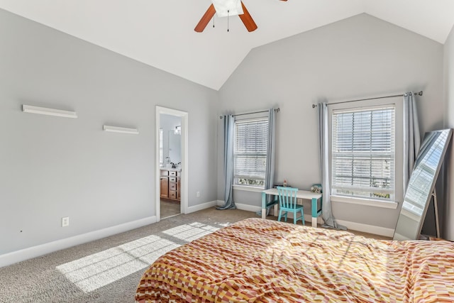 bedroom featuring lofted ceiling, connected bathroom, multiple windows, and ceiling fan