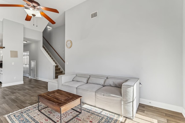 living room featuring hardwood / wood-style flooring, high vaulted ceiling, and ceiling fan