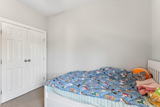 bedroom with carpet and a closet