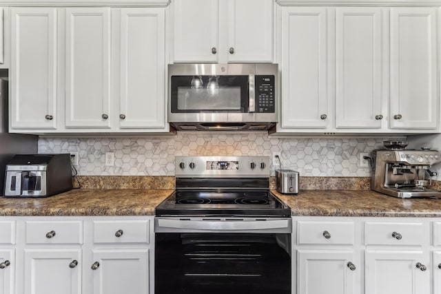 kitchen featuring stainless steel appliances, tasteful backsplash, and white cabinets