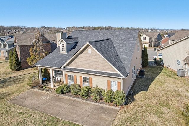 view of front of home featuring central AC and a front lawn