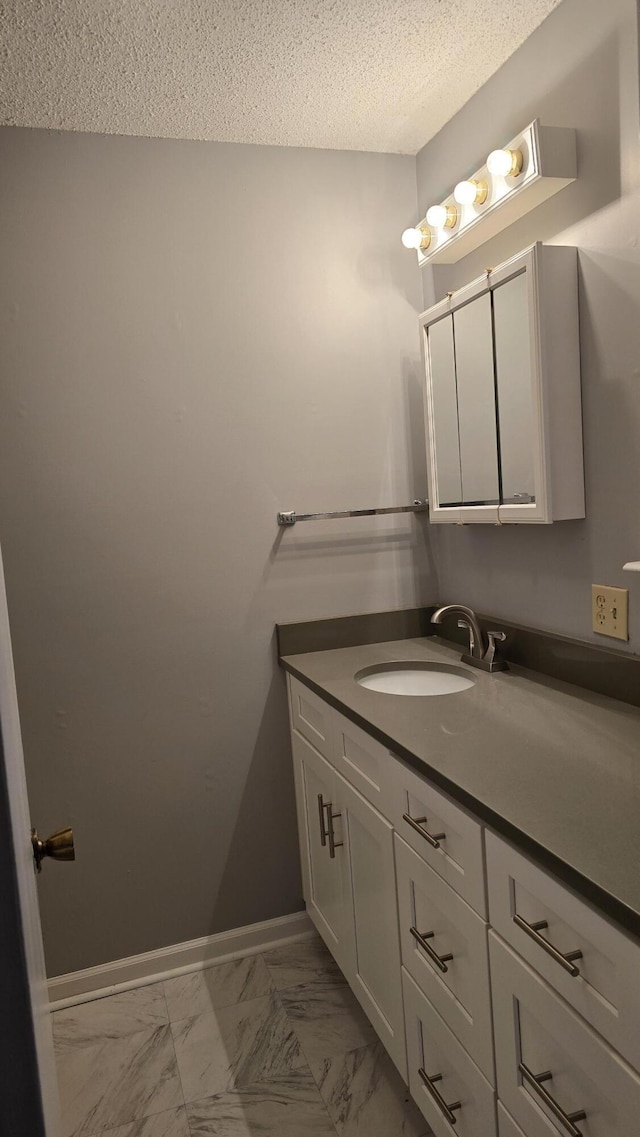 bathroom with vanity and a textured ceiling