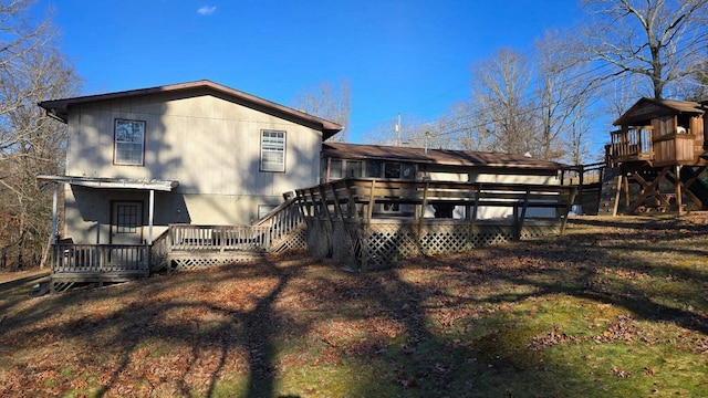 rear view of house featuring a wooden deck